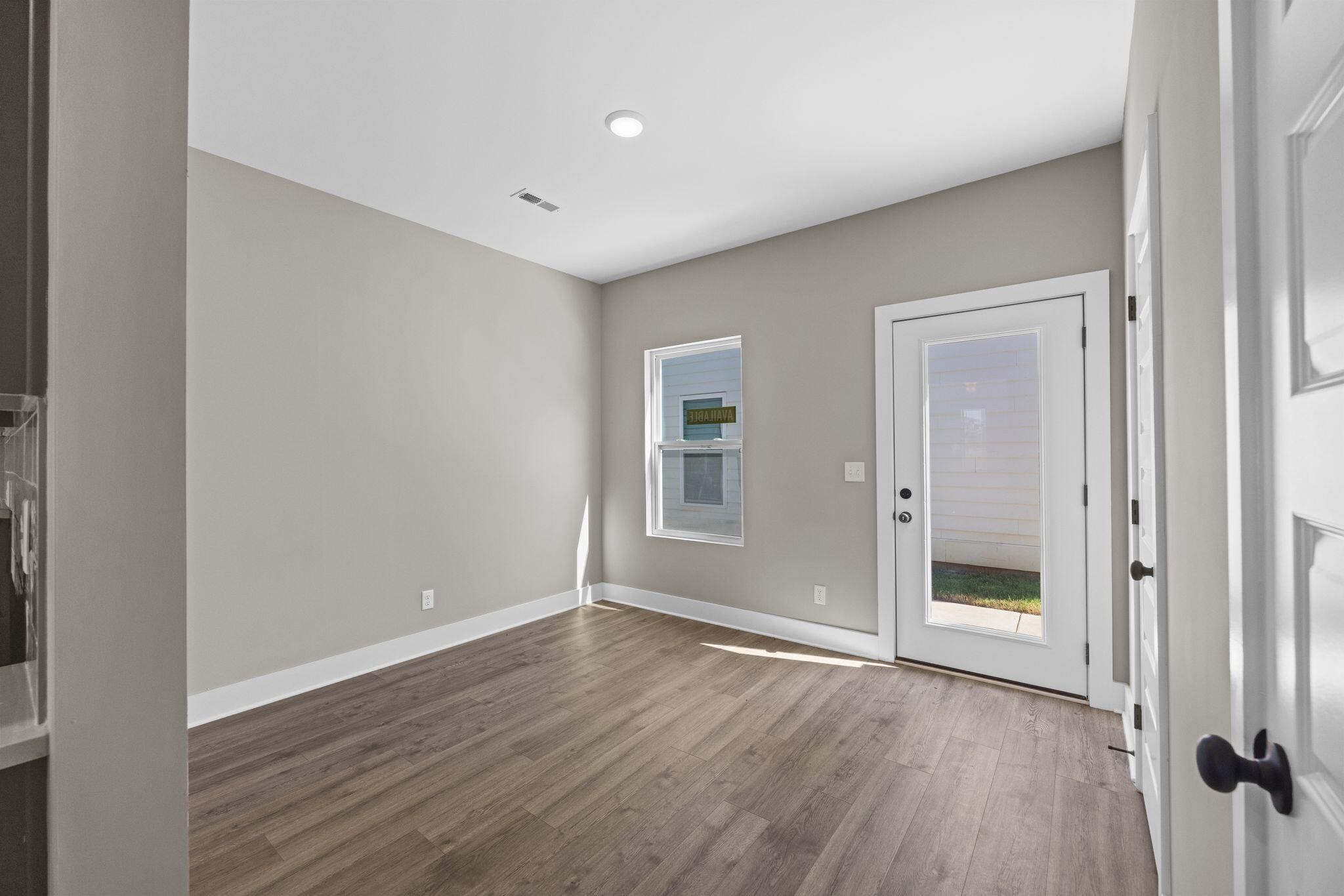 2413 East 17th Street Chattanooga, TN 37404 - Photo 10 of 42 a view of an empty room with wooden floor and a window