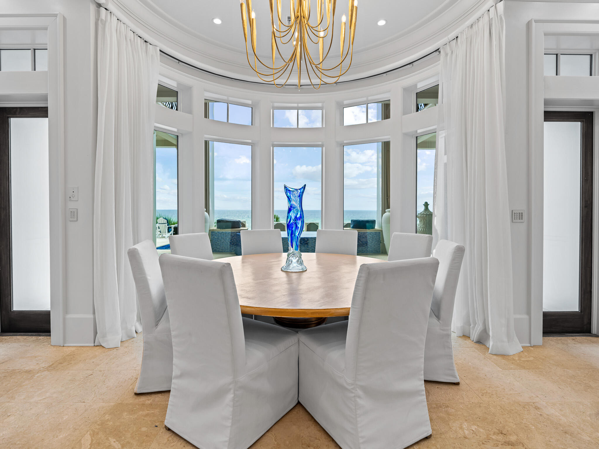 756 Blue Mountain Road Santa Rosa Beach, FL 32459 - Photo 24 of 86 a view of a dining room with furniture and a chandelier