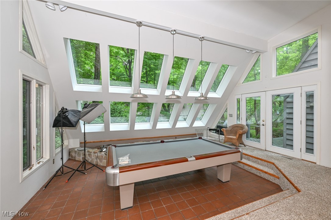 7061 Cascade Road Painesville, OH 44077 - Photo 28 of 49 Playroom with high vaulted ceiling, a skylight, plenty of natural light, and tile patterned flooring