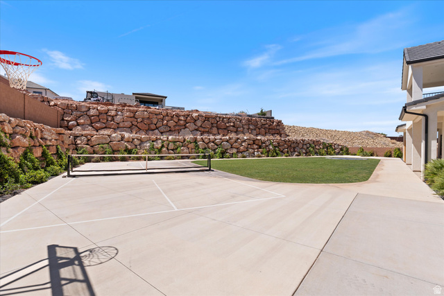 1192 East Corral Way Washington, UT 84780 - Photo 65 of 81 Outdoor hardscape court with painted lines for sports, a basketball hoop, and a portable net