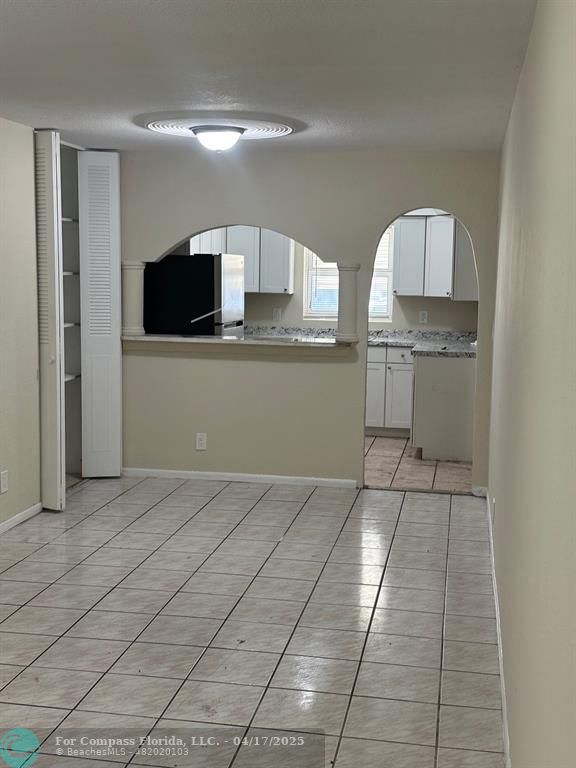 1350 East Sample Road, Unit 101 Pompano Beach, FL 33064 - Photo 2 of 8 a view of a kitchen with kitchen appliances and cabinets