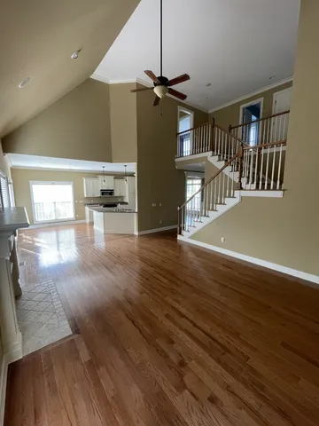 a view of a living room a dining room with wooden floor
