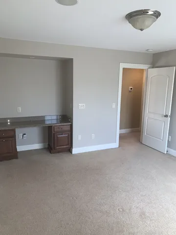 a view of an empty room with a cabinet