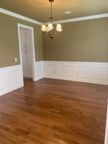 a view of a room with wooden floor and staircase