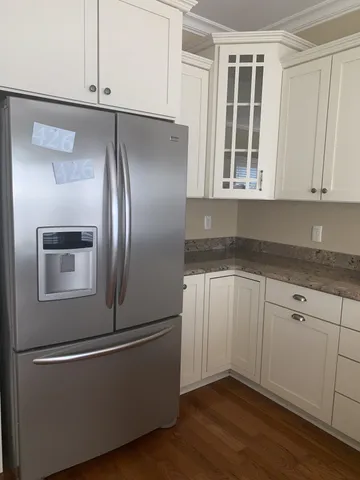 a kitchen with granite countertop stainless steel appliances and wooden cabinets