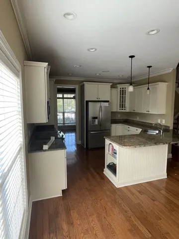 a kitchen with a stove a refrigerator and a sink