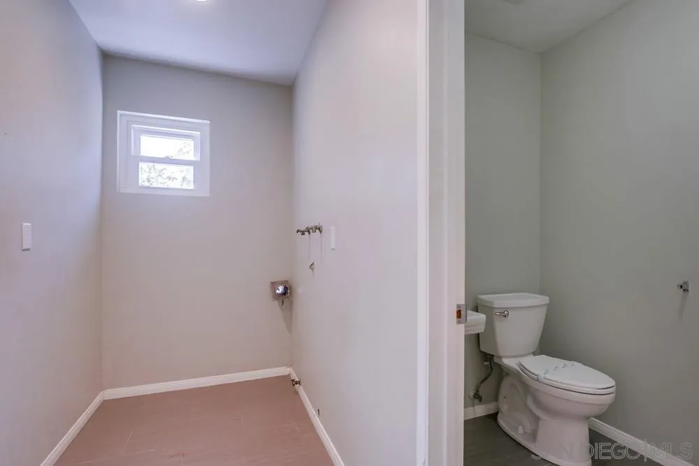 243 East View Street Fallbrook, CA 92028 - Photo 20 of 50 a white toilet sitting next to a small window