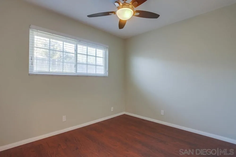 243 East View Street Fallbrook, CA 92028 - Photo 36 of 50 an empty room with wooden floor and windows