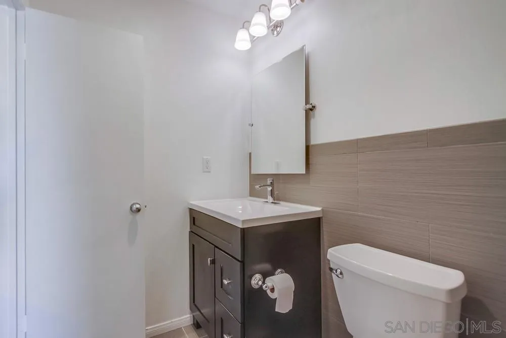 243 East View Street Fallbrook, CA 92028 - Photo 44 of 50 a bathroom with a toilet a sink and mirror