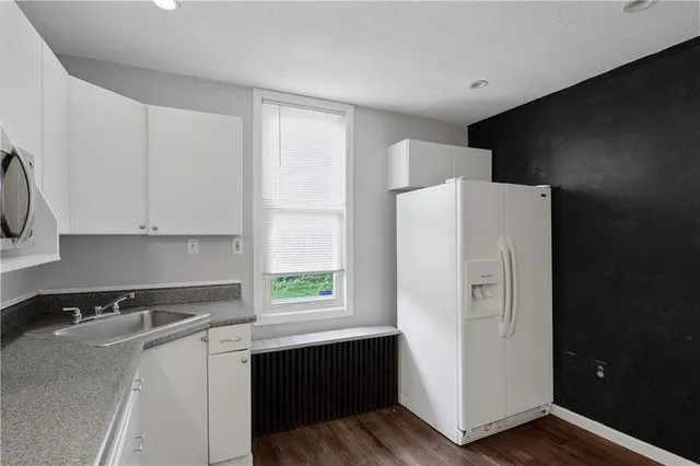 a utility room with cabinets washer and dryer