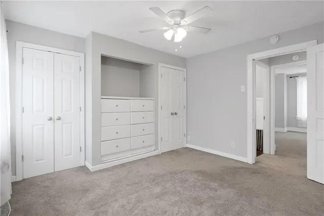 a view of an empty room with a ceiling fan