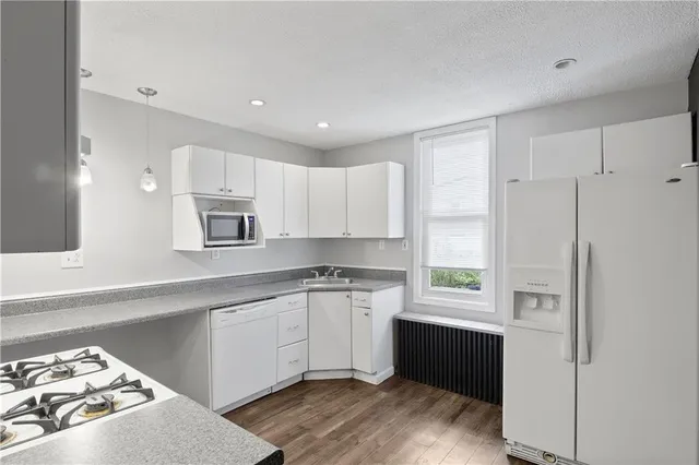 a kitchen with a sink stove and refrigerator