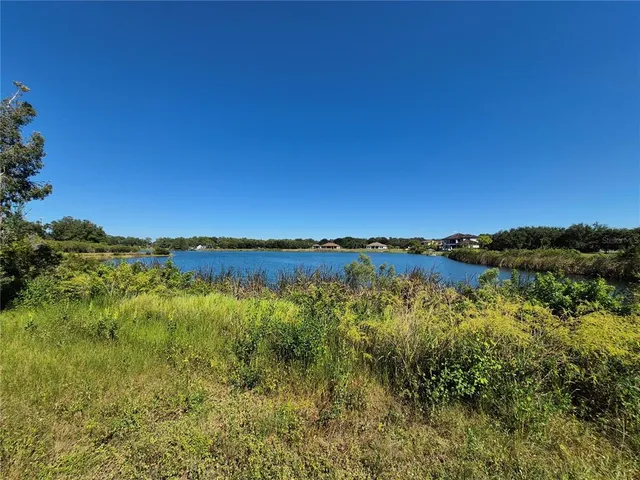 a view of a large body of water with a building in the background