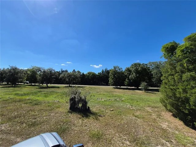 a view of outdoor space with deck and yard