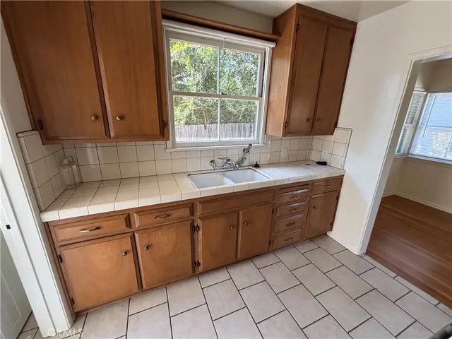 a spacious bathroom with a sink mirror and window