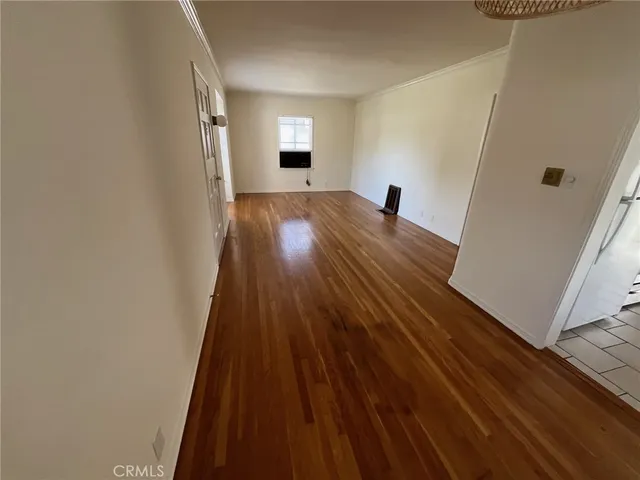 a view of a room with wooden floor