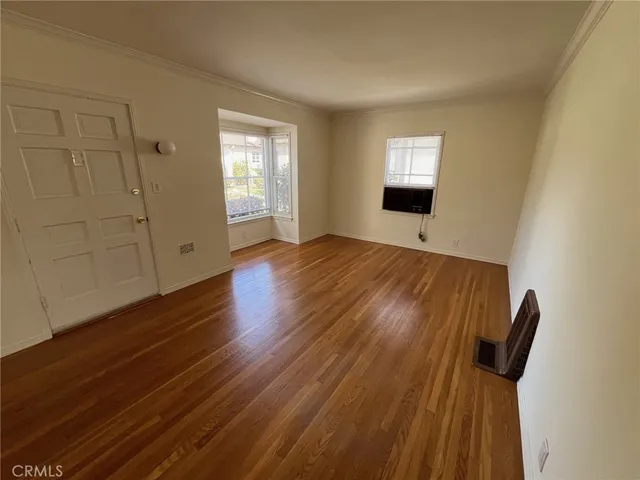 a view of entryway with wooden floor and window