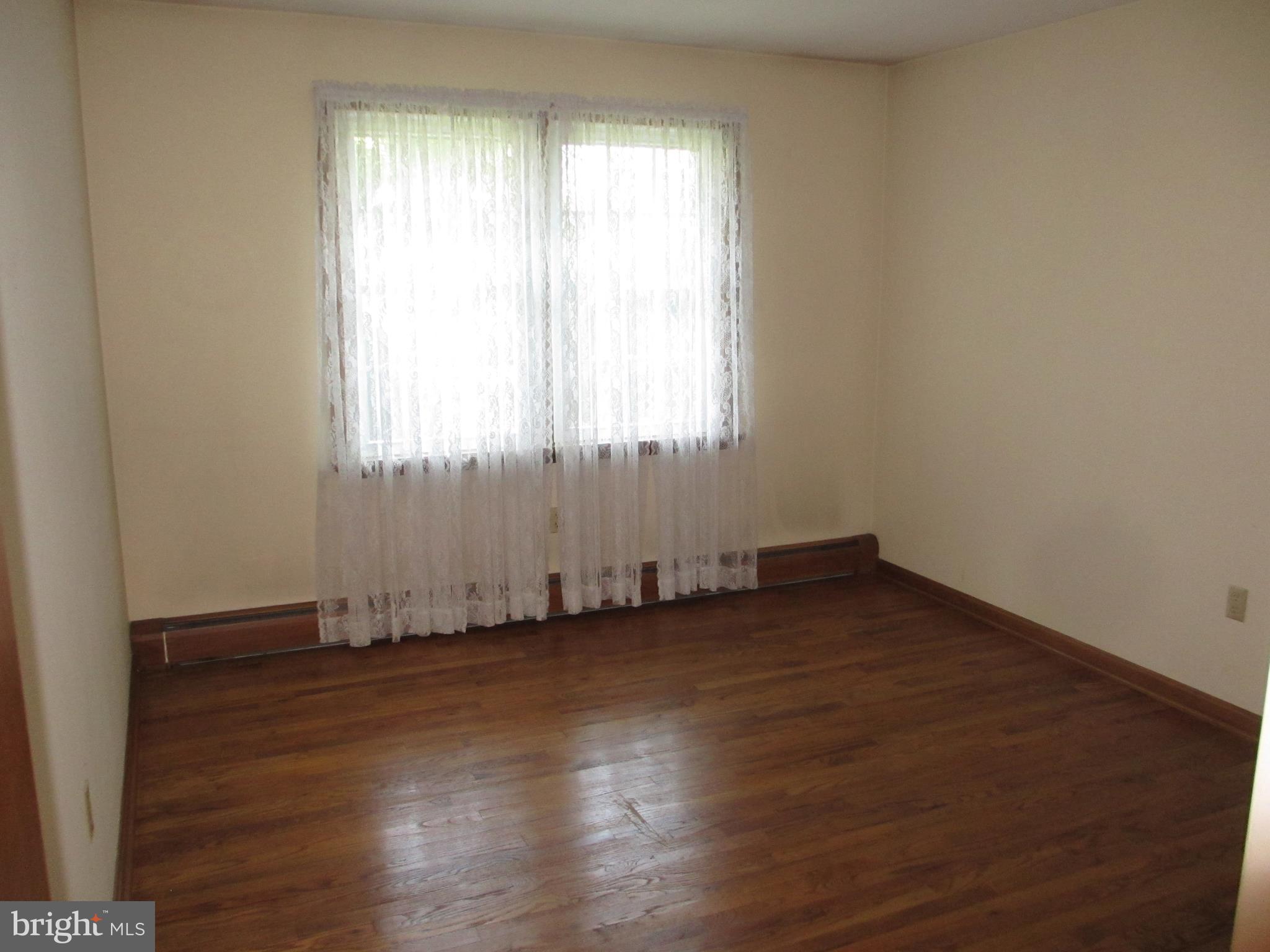 16 Nellies Corner Road Rising Sun, MD 21911 - Photo 11 of 25 an empty room with wooden floor and windows