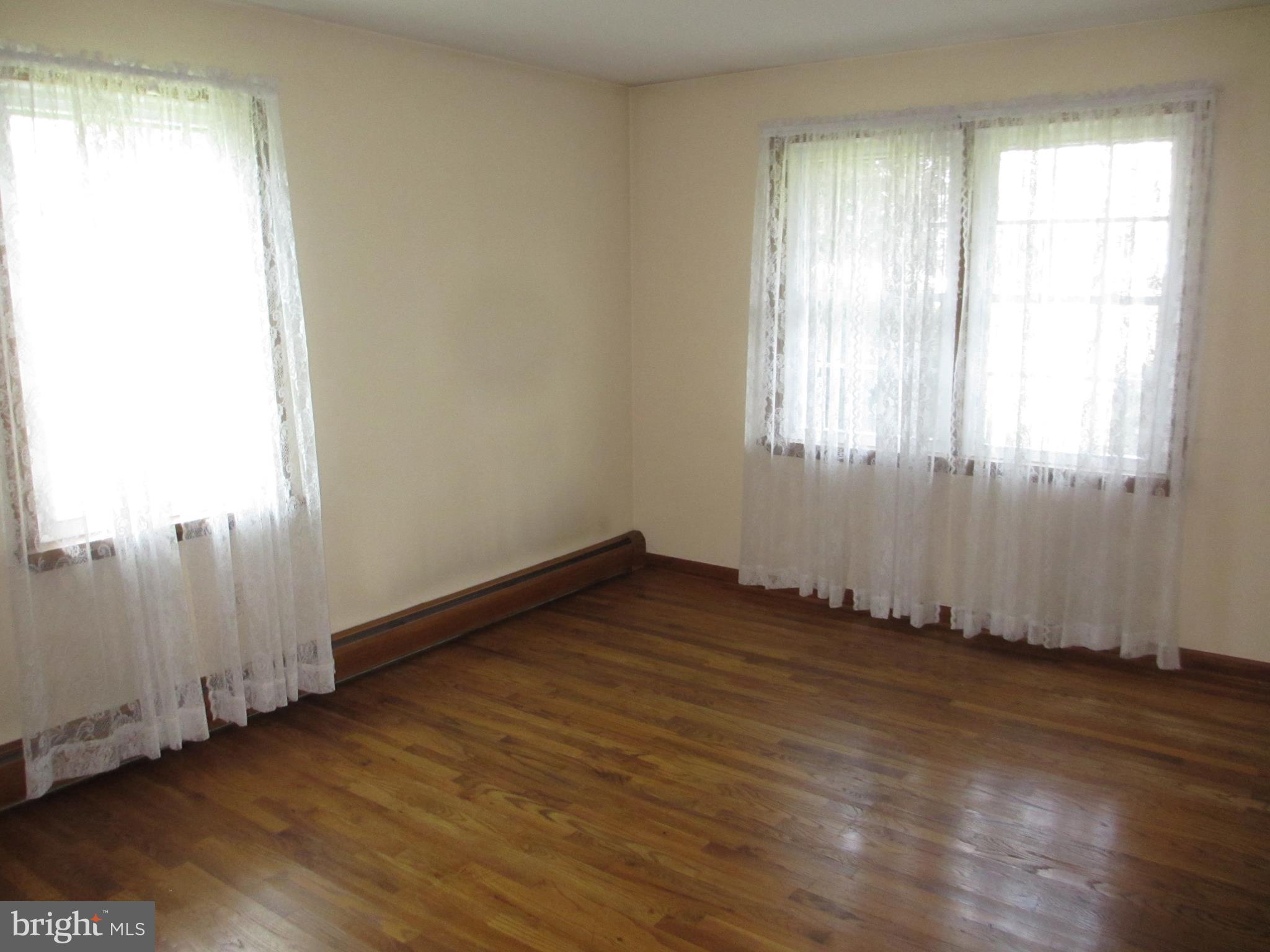 16 Nellies Corner Road Rising Sun, MD 21911 - Photo 12 of 25 an empty room with wooden floor and windows