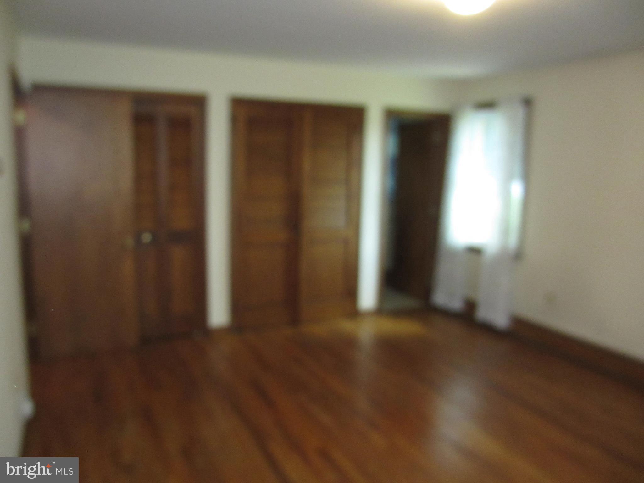 16 Nellies Corner Road Rising Sun, MD 21911 - Photo 13 of 25 an empty room with wooden floor and windows