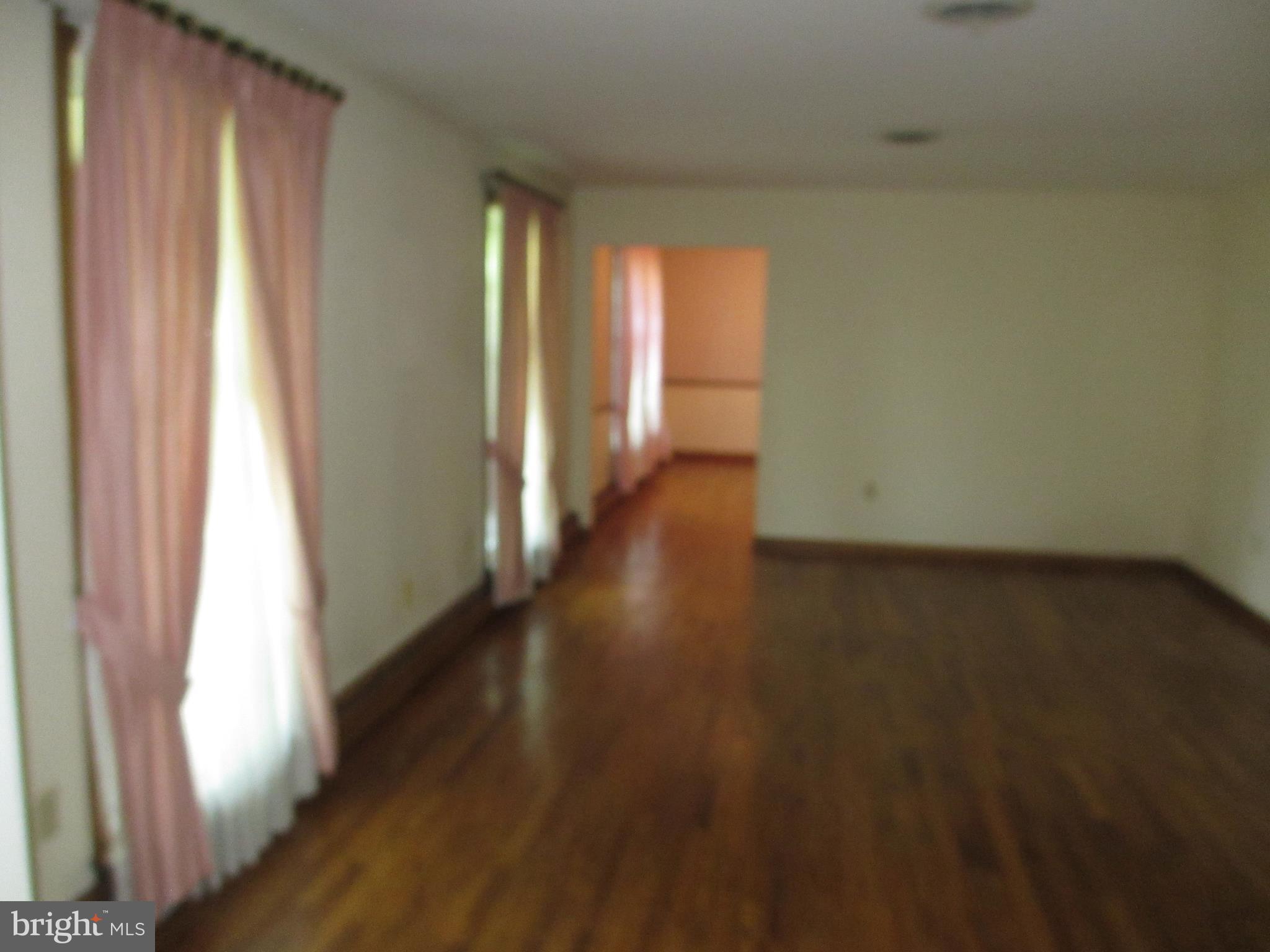 16 Nellies Corner Road Rising Sun, MD 21911 - Photo 15 of 25 a view of an empty room with wooden floor and a window
