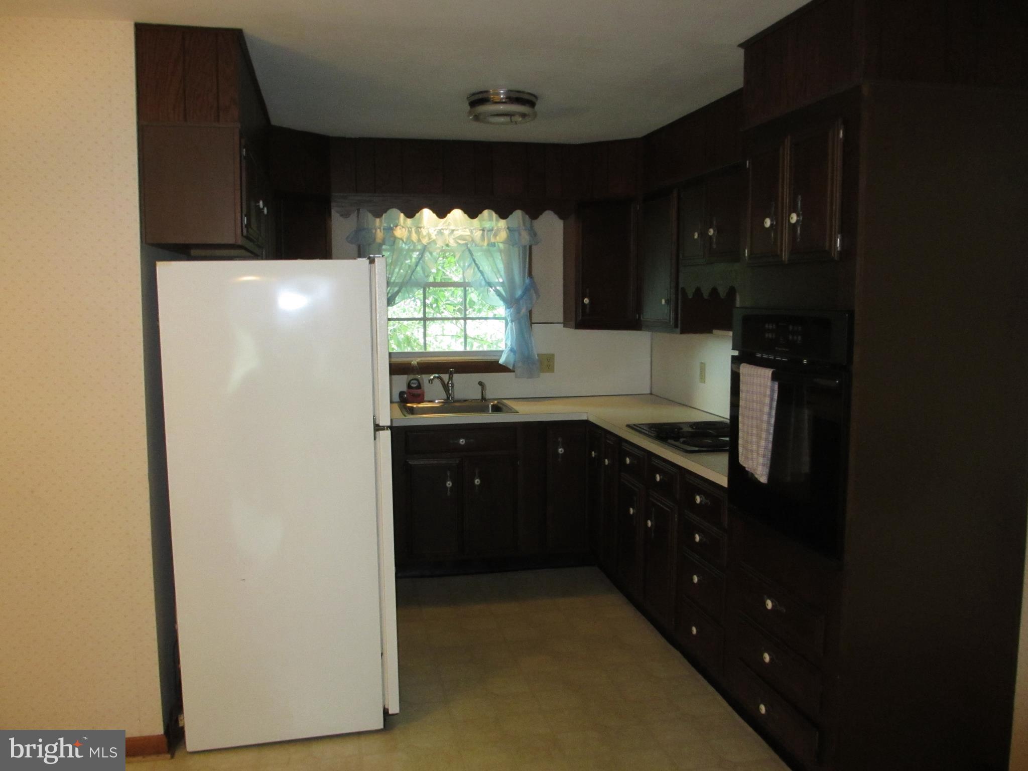 16 Nellies Corner Road Rising Sun, MD 21911 - Photo 22 of 25 a kitchen with a refrigerator and a stove