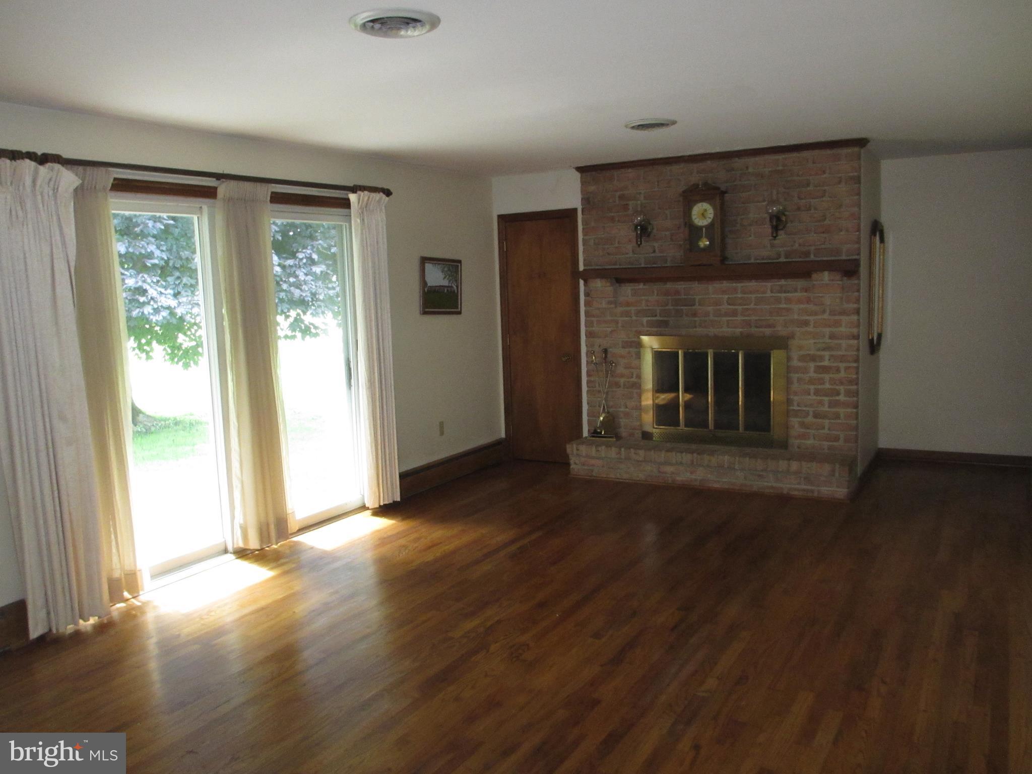 16 Nellies Corner Road Rising Sun, MD 21911 - Photo 4 of 25 a view of empty room with wooden floor and fireplace