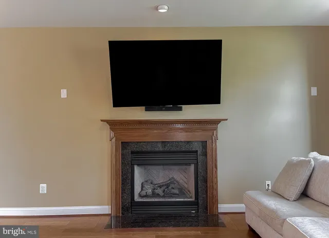 a kitchen with stainless steel appliances a refrigerator a stove a sink cabinets and wooden floor