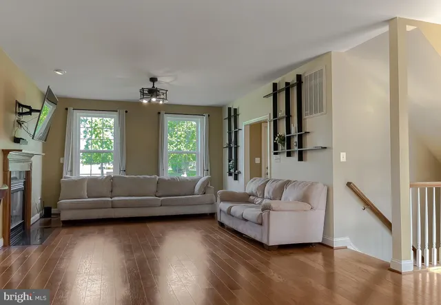 a kitchen with stainless steel appliances granite countertop a sink a stove and a wooden floors