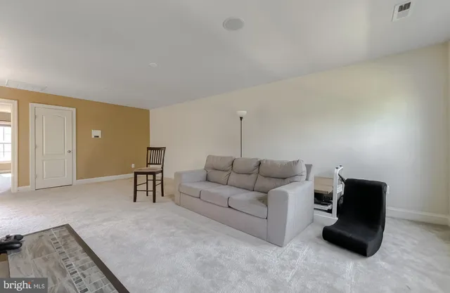 a view of an empty room and wooden floor