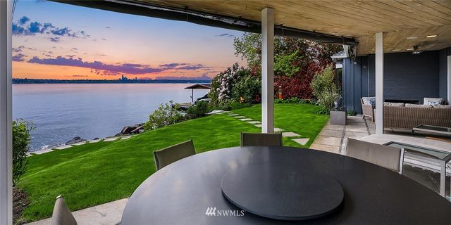 a view of a backyard with garden and patio