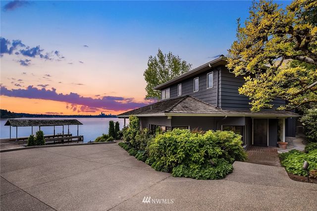 a view of house with swimming pool and outdoor seating