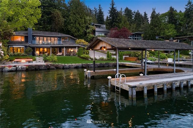 a view of house with swimming pool and outdoor seating