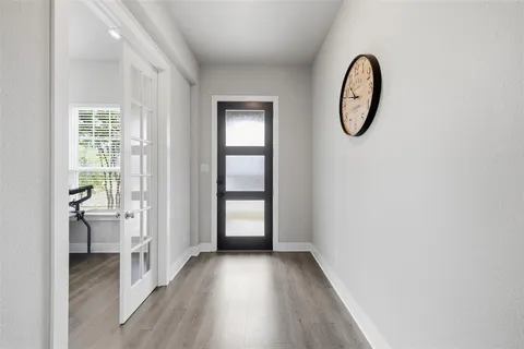 a view of a room with wooden floor and windows