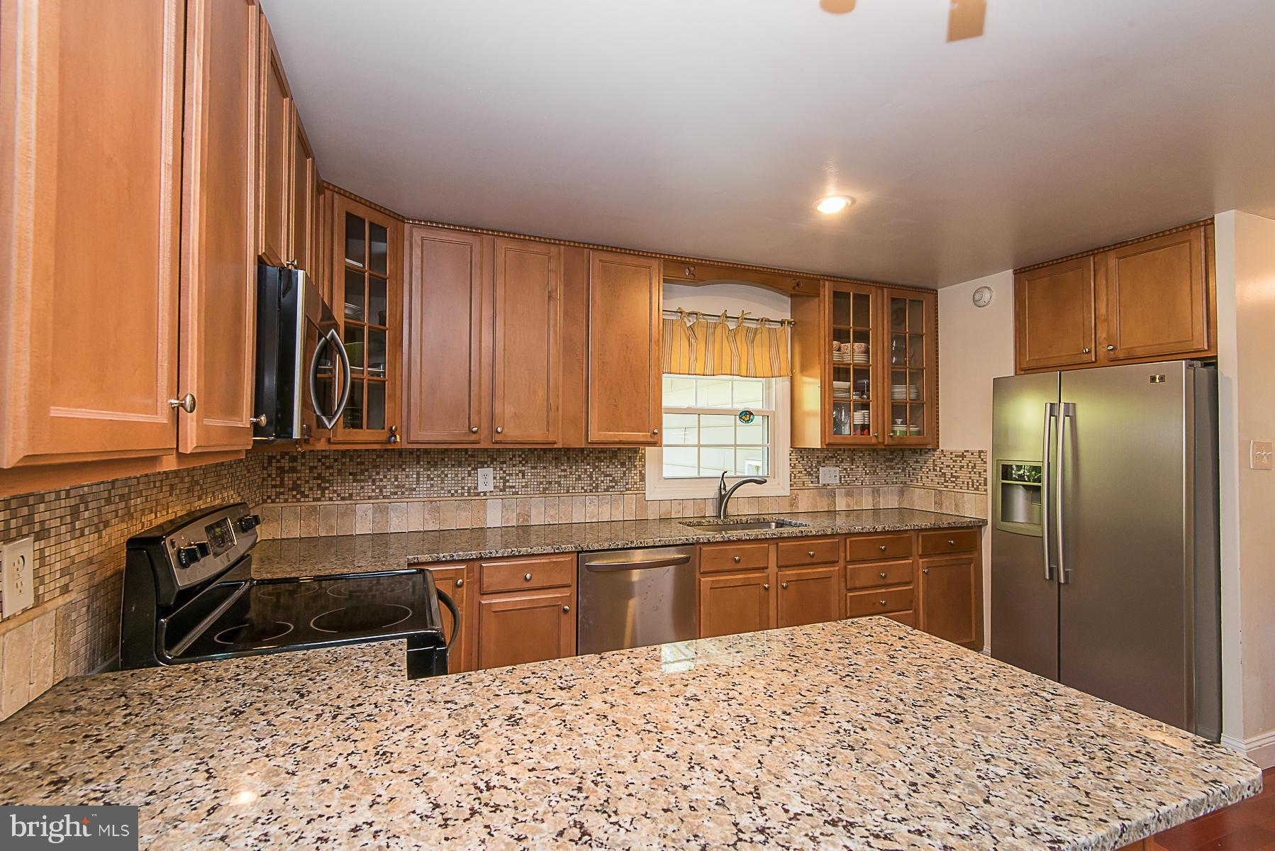 4050 Macalpine Road Ellicott City, MD 21042 - Photo 12 of 30 a kitchen with stainless steel appliances granite countertop a sink stove and refrigerator