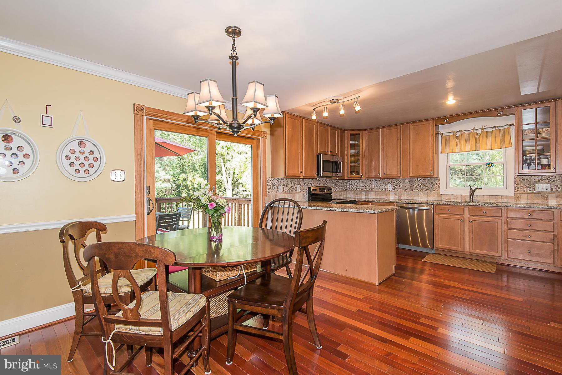 4050 Macalpine Road Ellicott City, MD 21042 - Photo 13 of 30 a view of a dining room with furniture window and wooden floor