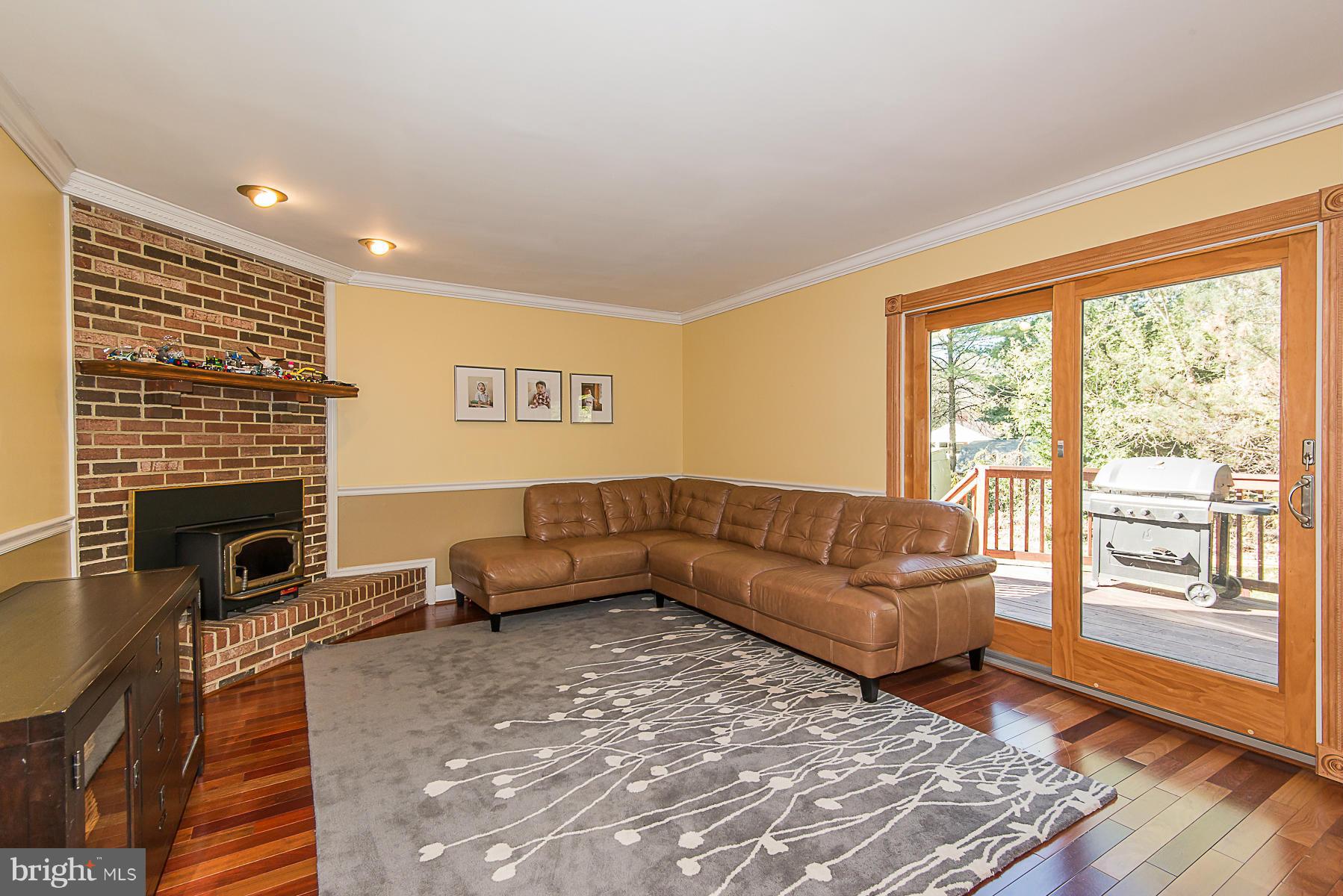 4050 Macalpine Road Ellicott City, MD 21042 - Photo 15 of 30 a living room with furniture and a fireplace