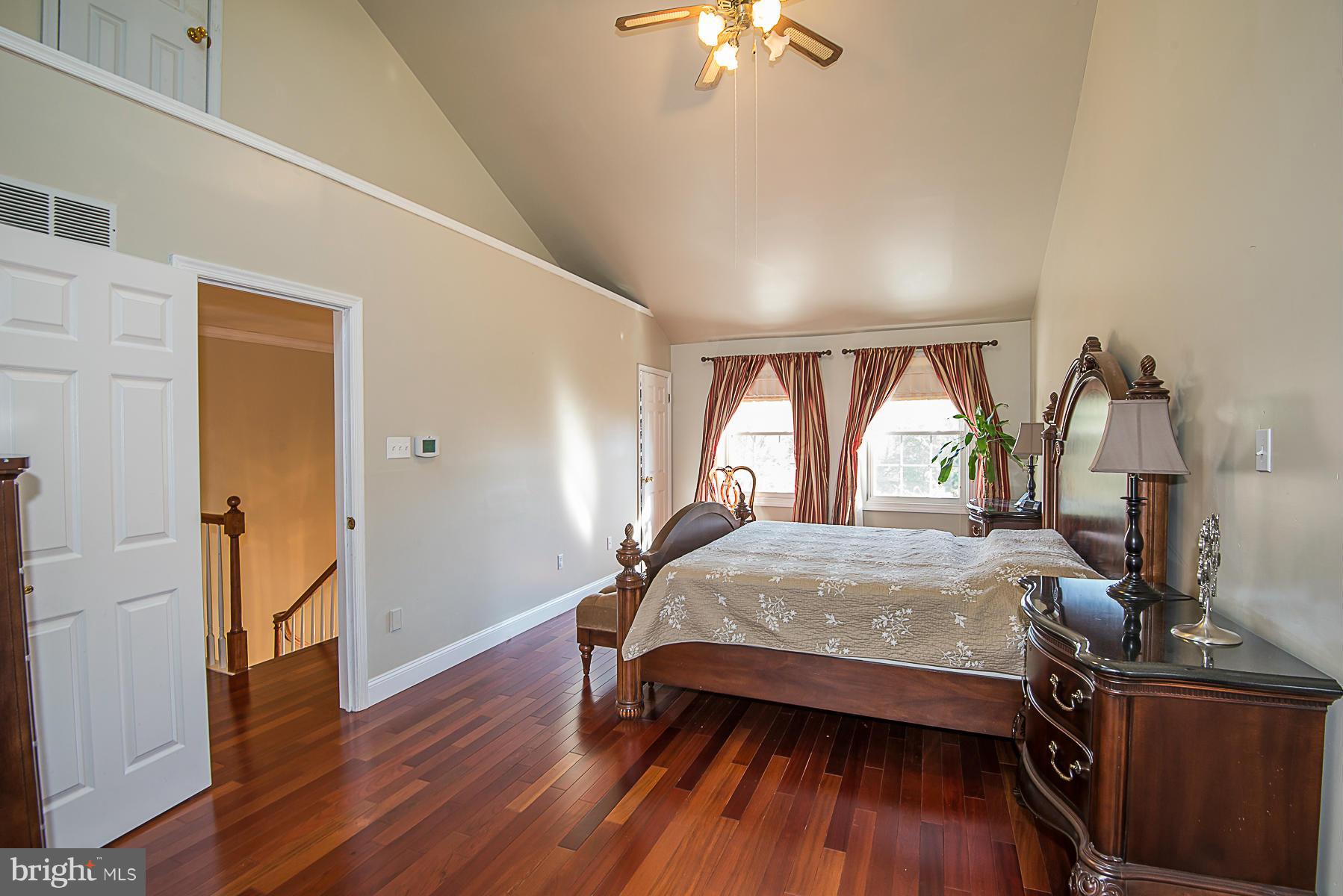 4050 Macalpine Road Ellicott City, MD 21042 - Photo 18 of 30 a bedroom with a bed and wooden floor