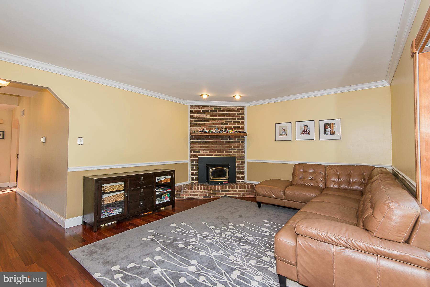 4050 Macalpine Road Ellicott City, MD 21042 - Photo 3 of 30 a living room with furniture a fireplace and a flat screen tv