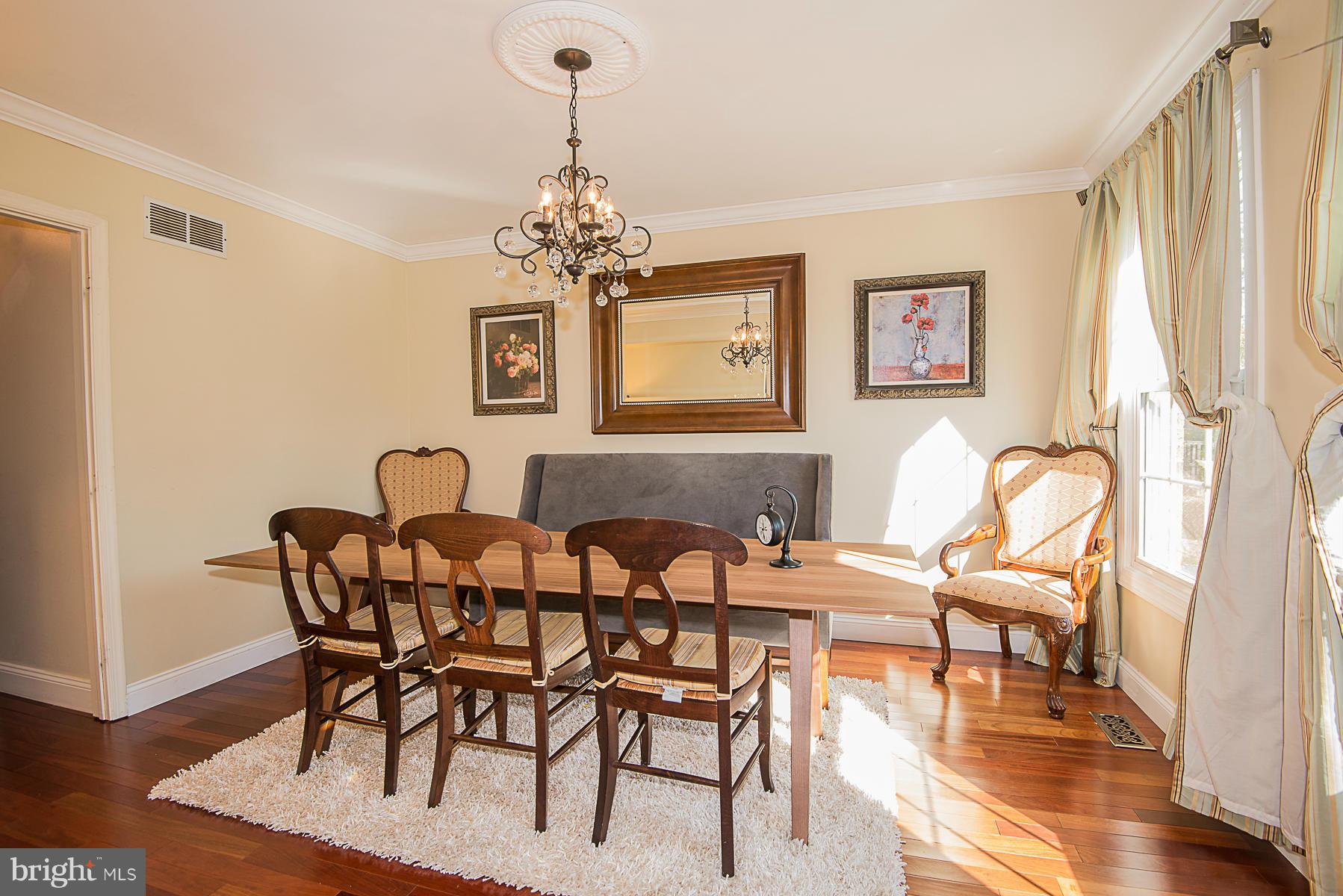 4050 Macalpine Road Ellicott City, MD 21042 - Photo 8 of 30 a view of a dining room with furniture wooden floor and a chandelier
