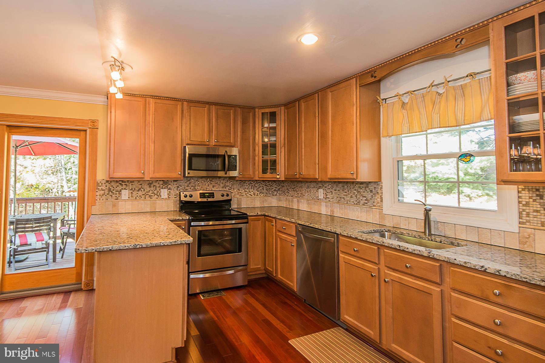 4050 Macalpine Road Ellicott City, MD 21042 - Photo 10 of 30 a kitchen with stainless steel appliances granite countertop a stove a sink and a microwave