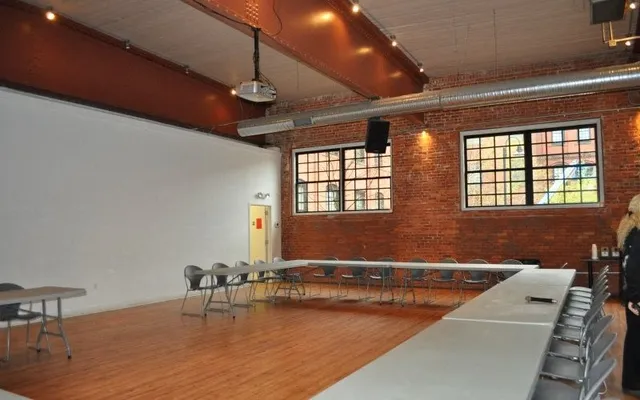 a living room with couches painted wall with wooden floor and a large window