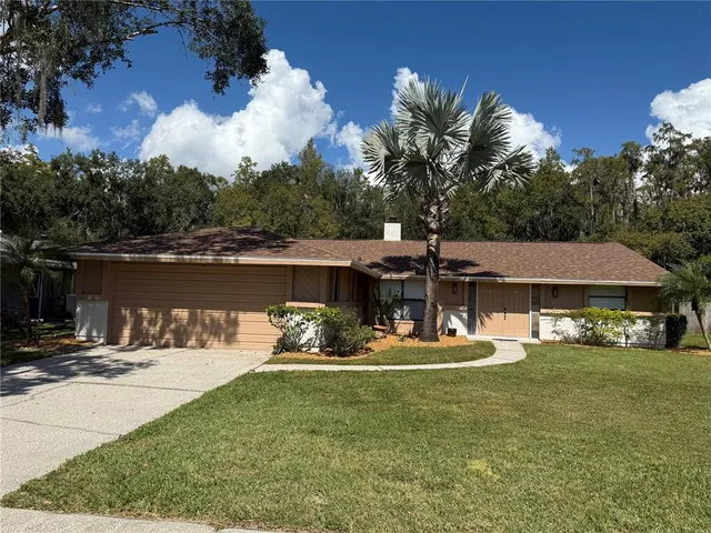a view of a house with backyard sitting area and lake view