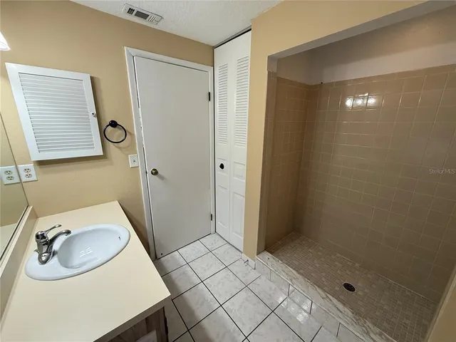 a kitchen with kitchen island wooden floors appliances and cabinets