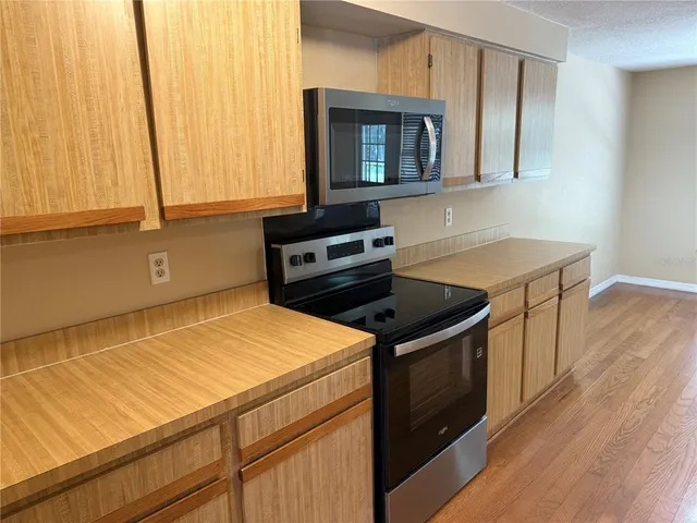 a stove top oven sitting inside of a kitchen