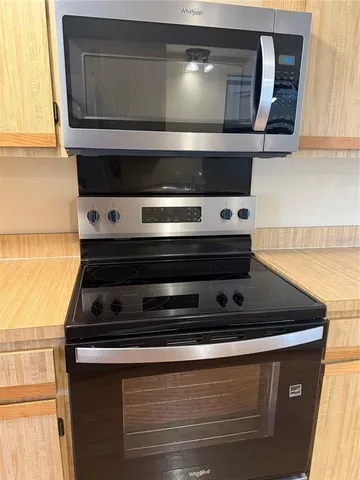 a kitchen with a sink stove and refrigerator