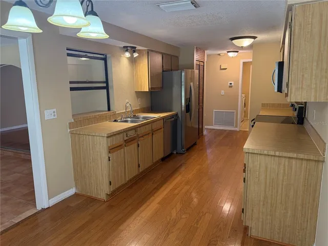 a view of a kitchen with a sink and a window