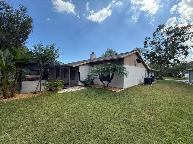 a view of a house with a yard and sitting area