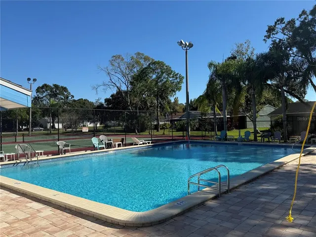 a view of a swimming pool with a yard