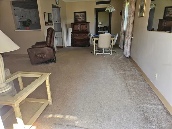 a living room with furniture and a chair